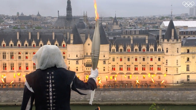 El portador de la llama frente a la escena de Libertad - Ceremonia apertura de los Juegos Olímpicos de París 2024