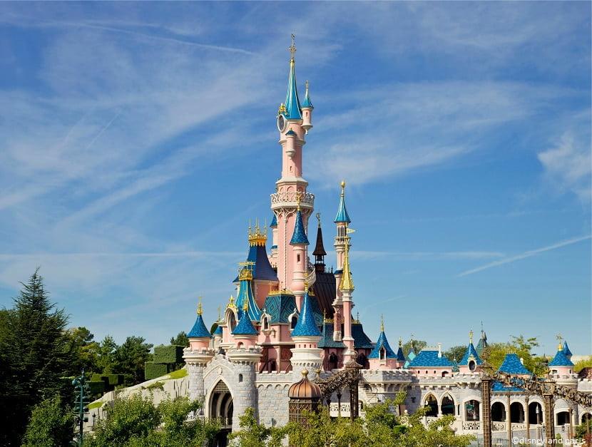 El Castillo de la Bella Durmiente de Disneyland Paris bajo un cielo azul despejado.